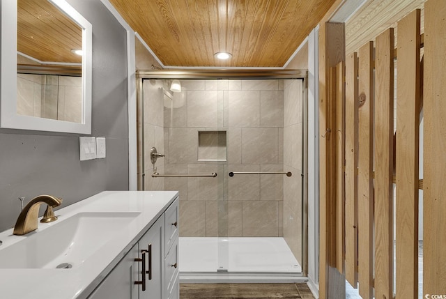 bathroom featuring an enclosed shower, wood ceiling, and large vanity