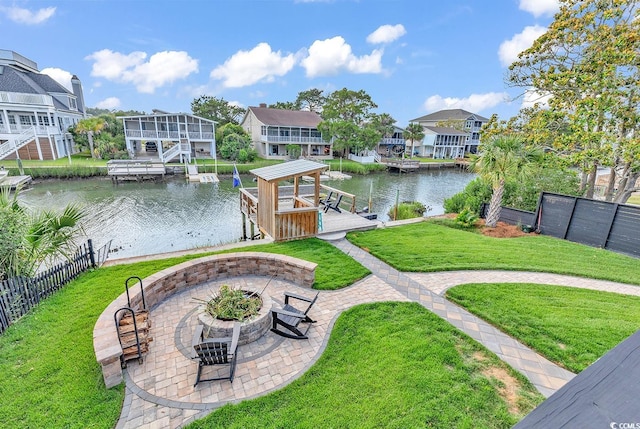 exterior space with a patio, a water view, a fire pit, and a dock