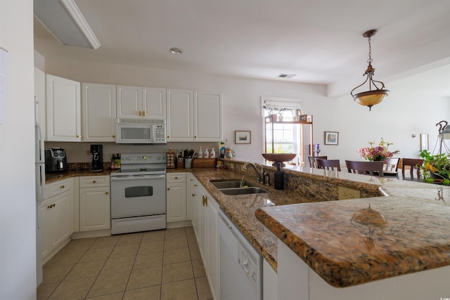 kitchen featuring kitchen peninsula, white appliances, sink, decorative light fixtures, and white cabinetry