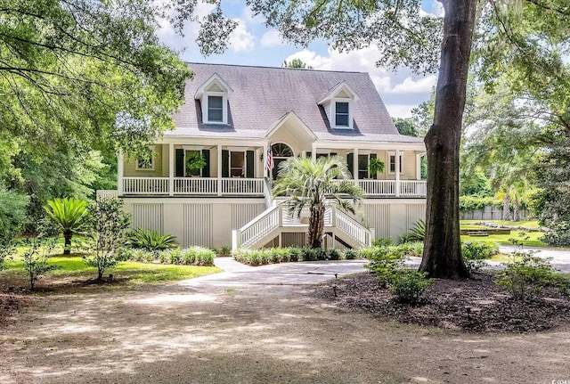 new england style home with covered porch