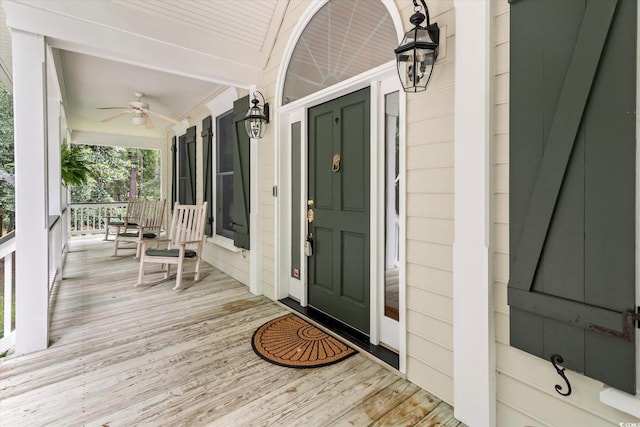 wooden deck featuring ceiling fan