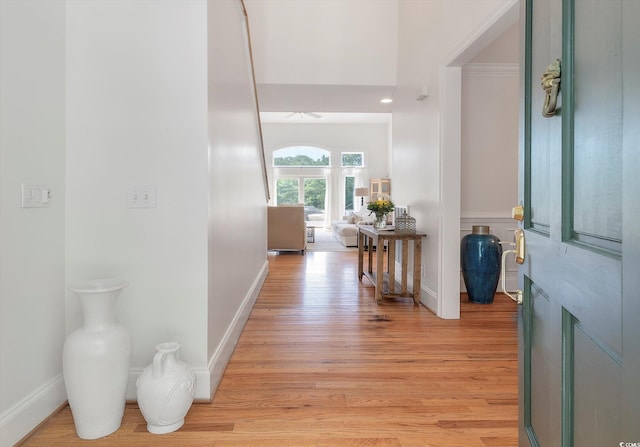 corridor with light hardwood / wood-style floors