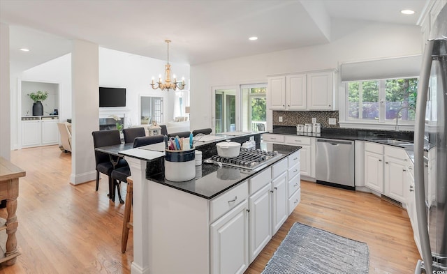 kitchen with stainless steel appliances, sink, a wealth of natural light, and a kitchen island