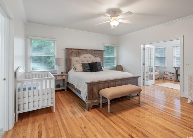 bedroom with ceiling fan, crown molding, and light hardwood / wood-style flooring