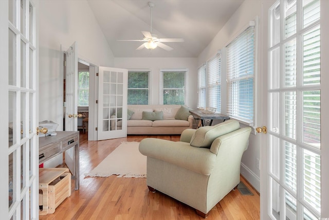 sunroom / solarium featuring plenty of natural light, french doors, ceiling fan, and vaulted ceiling