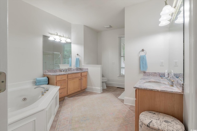 bathroom featuring vanity, a bath, toilet, and tile patterned floors