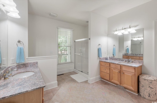 bathroom with vanity, tile patterned flooring, and walk in shower