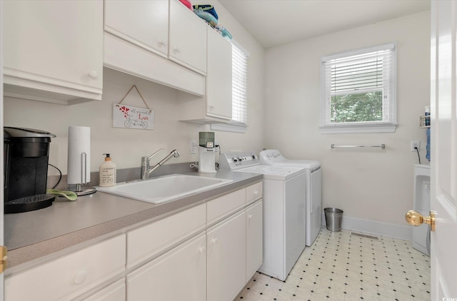 laundry room with washer and clothes dryer, sink, cabinets, and light tile patterned floors