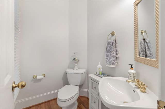 bathroom with sink, hardwood / wood-style flooring, and toilet