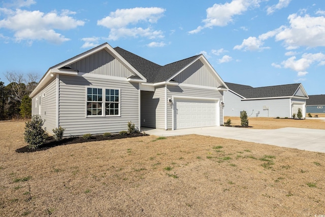 view of front of home featuring a garage and a front lawn