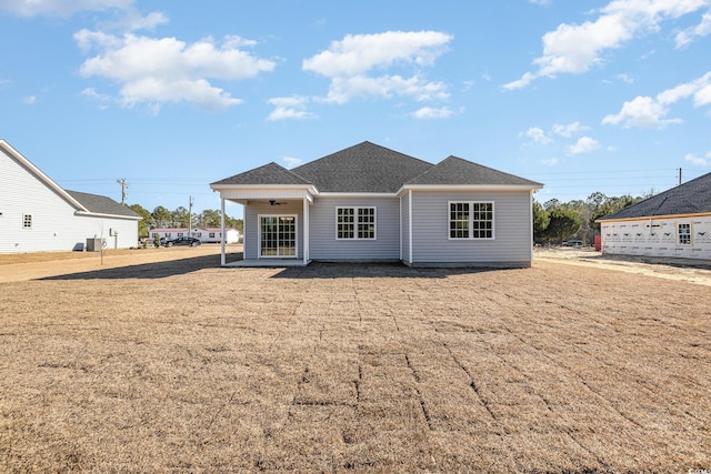 rear view of property with ceiling fan