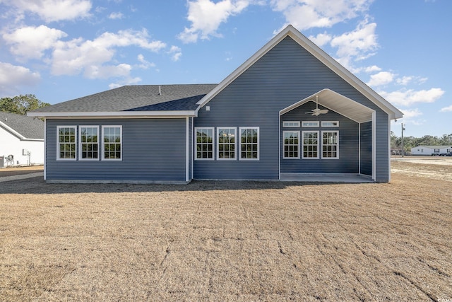 rear view of house featuring ceiling fan and a patio area