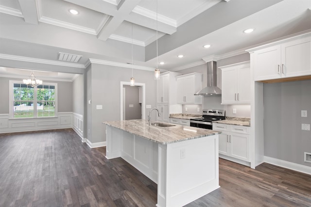 kitchen with an island with sink, stainless steel electric range, white cabinetry, and wall chimney range hood