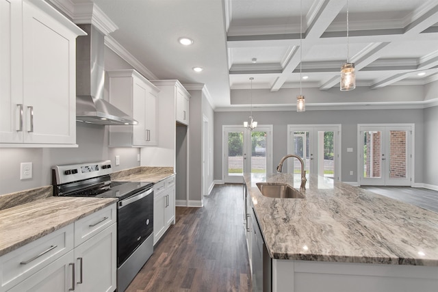 kitchen featuring a kitchen island with sink, sink, dark hardwood / wood-style flooring, stainless steel range with electric stovetop, and french doors