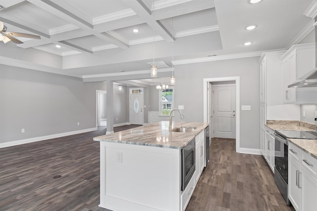 kitchen with ceiling fan with notable chandelier, white cabinets, a center island with sink, and appliances with stainless steel finishes