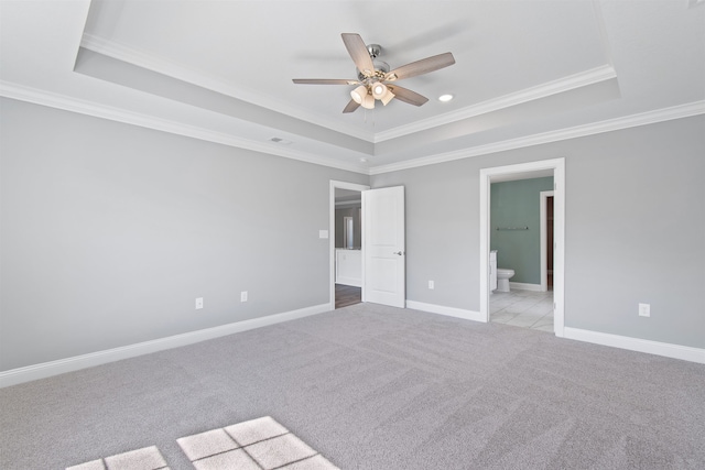 unfurnished room with ornamental molding, a tray ceiling, and ceiling fan