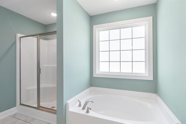 bathroom featuring independent shower and bath