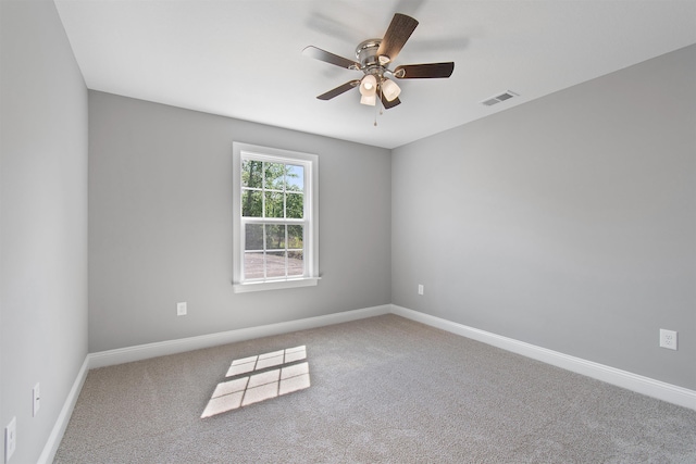 spare room featuring carpet floors and ceiling fan