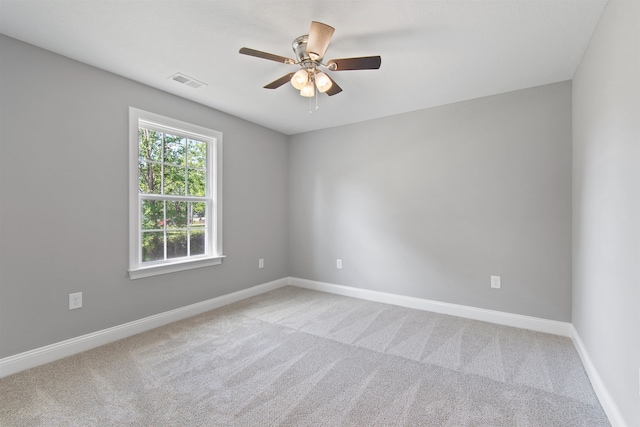 carpeted spare room with ceiling fan