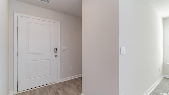 entryway featuring light wood-style flooring and baseboards