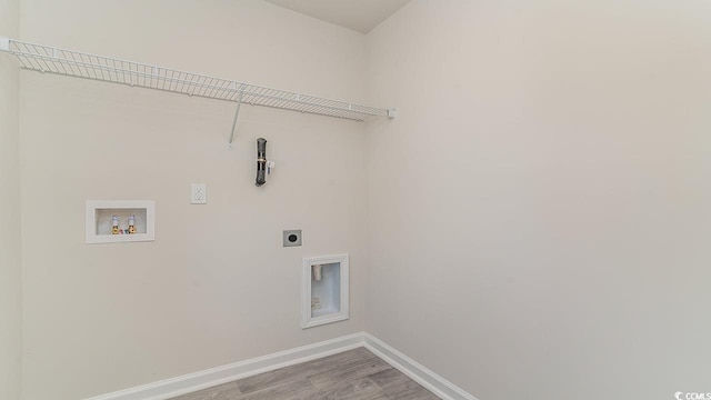 washroom with washer hookup, wood finished floors, baseboards, hookup for an electric dryer, and laundry area