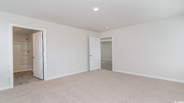 unfurnished bedroom featuring baseboards and carpet floors