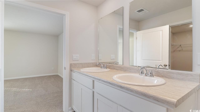 full bathroom with double vanity, visible vents, baseboards, and a sink