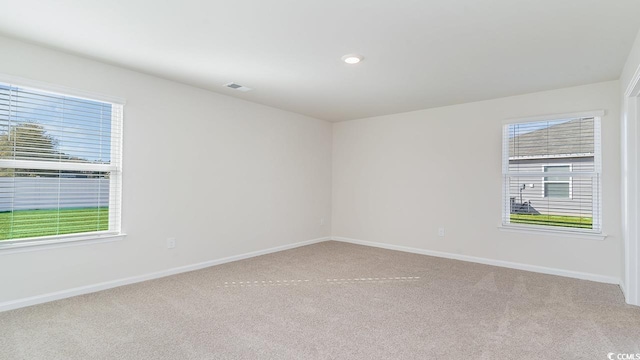 unfurnished room with visible vents, recessed lighting, baseboards, and carpet floors