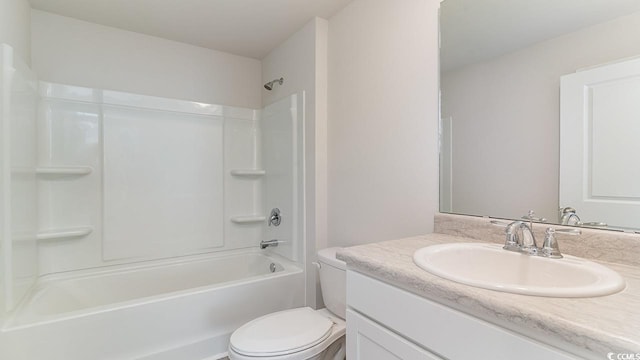 bathroom featuring toilet, vanity, and bathtub / shower combination