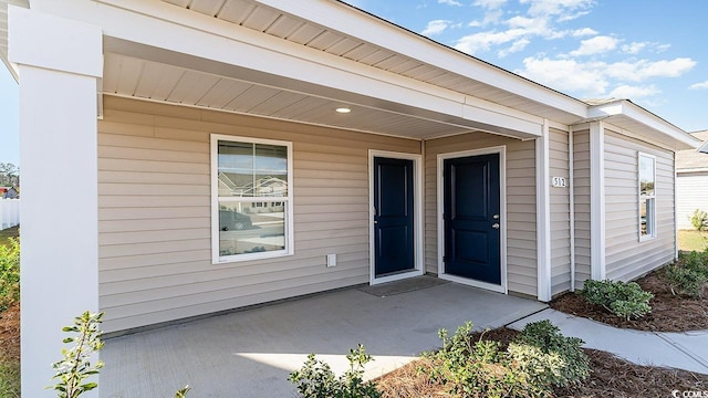 property entrance featuring a patio