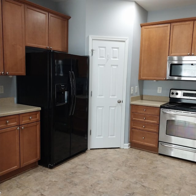 kitchen with stainless steel appliances and light tile floors