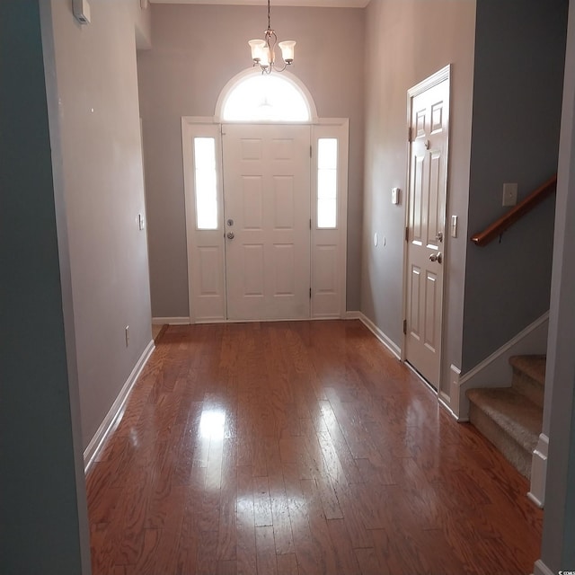 foyer with a chandelier and hardwood / wood-style flooring