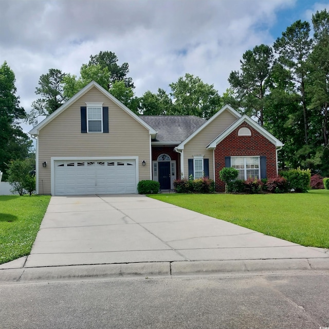 view of front of home with a front yard and a garage