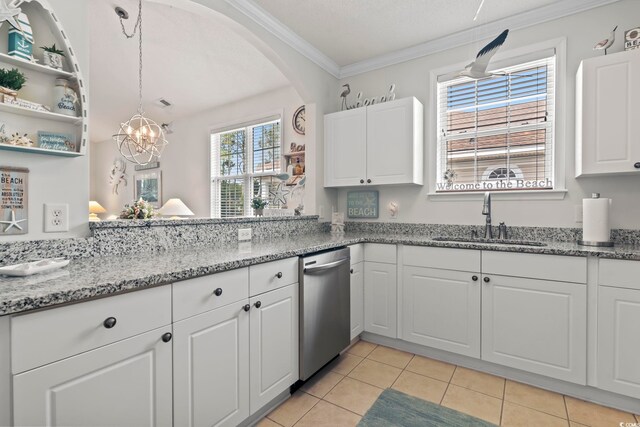 kitchen featuring light stone counters, a wealth of natural light, sink, light tile patterned floors, and white cabinets