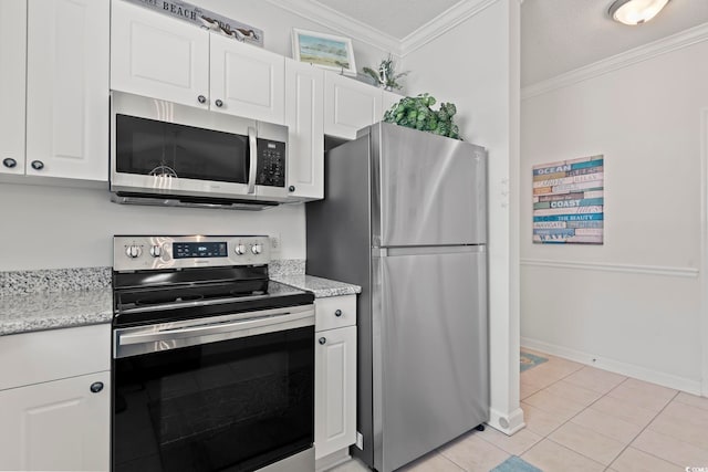 kitchen featuring white cabinets, light tile patterned floors, stainless steel appliances, and crown molding