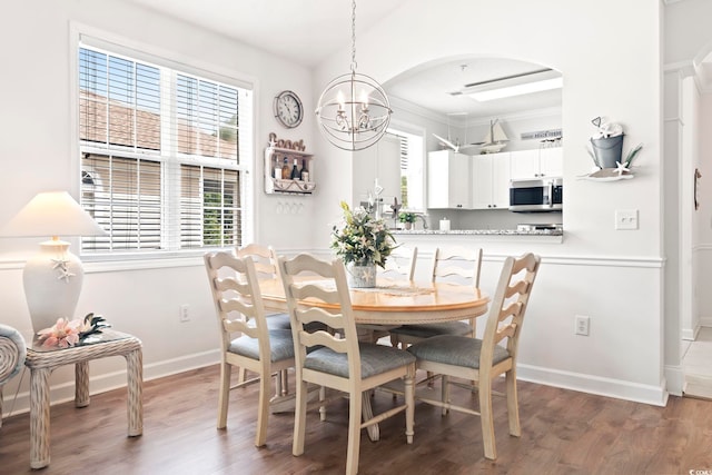 dining room featuring a chandelier and dark wood-type flooring