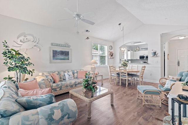 living room featuring hardwood / wood-style flooring, ceiling fan, and vaulted ceiling