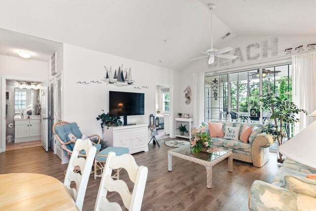 living room featuring hardwood / wood-style floors, ceiling fan, and vaulted ceiling