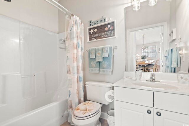 full bathroom featuring shower / bath combo with shower curtain, vanity, and toilet