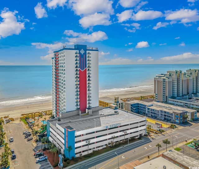 drone / aerial view with a water view and a beach view