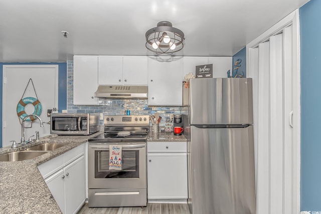 kitchen featuring white cabinetry, stainless steel appliances, stone countertops, and sink