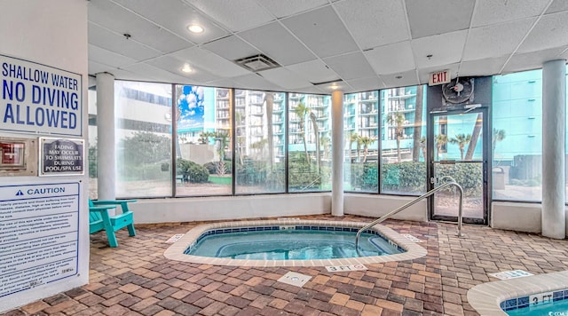 view of pool with an indoor hot tub