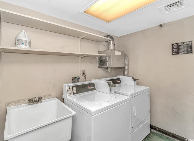 laundry area with washing machine and dryer and sink