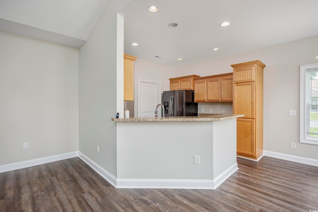 kitchen featuring stainless steel fridge, kitchen peninsula, dark hardwood / wood-style flooring, and sink