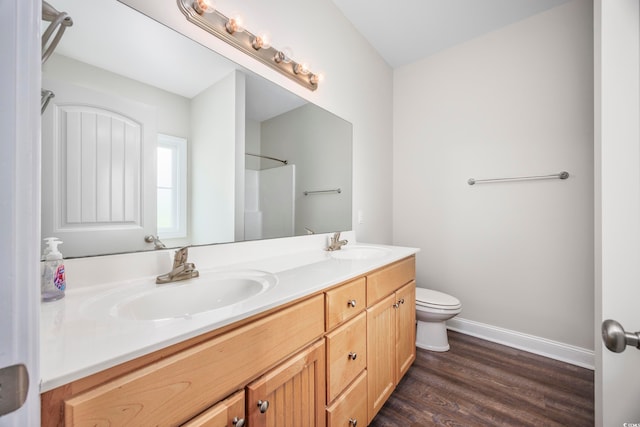 bathroom with walk in shower, vanity, toilet, and hardwood / wood-style flooring