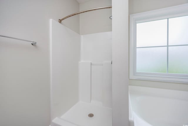 bathroom with separate shower and tub