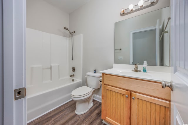 full bathroom with tub / shower combination, vanity, hardwood / wood-style floors, and toilet