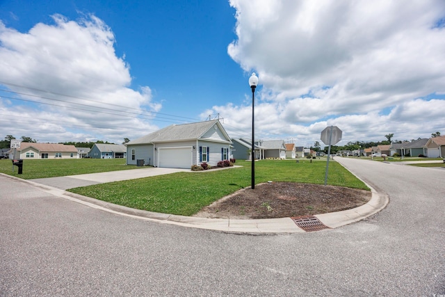 view of front of property featuring a front lawn and a garage