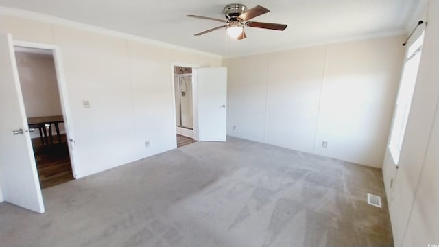 unfurnished bedroom featuring a closet, ornamental molding, carpet, and ceiling fan