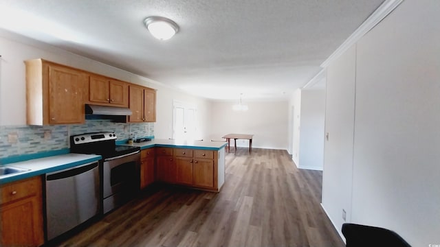 kitchen featuring dark hardwood / wood-style floors, kitchen peninsula, stainless steel appliances, crown molding, and decorative light fixtures